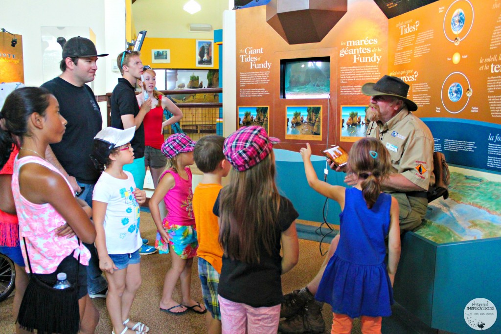 Kevin Snair teaches a group of kids about the tide at Hopewell Rocks.