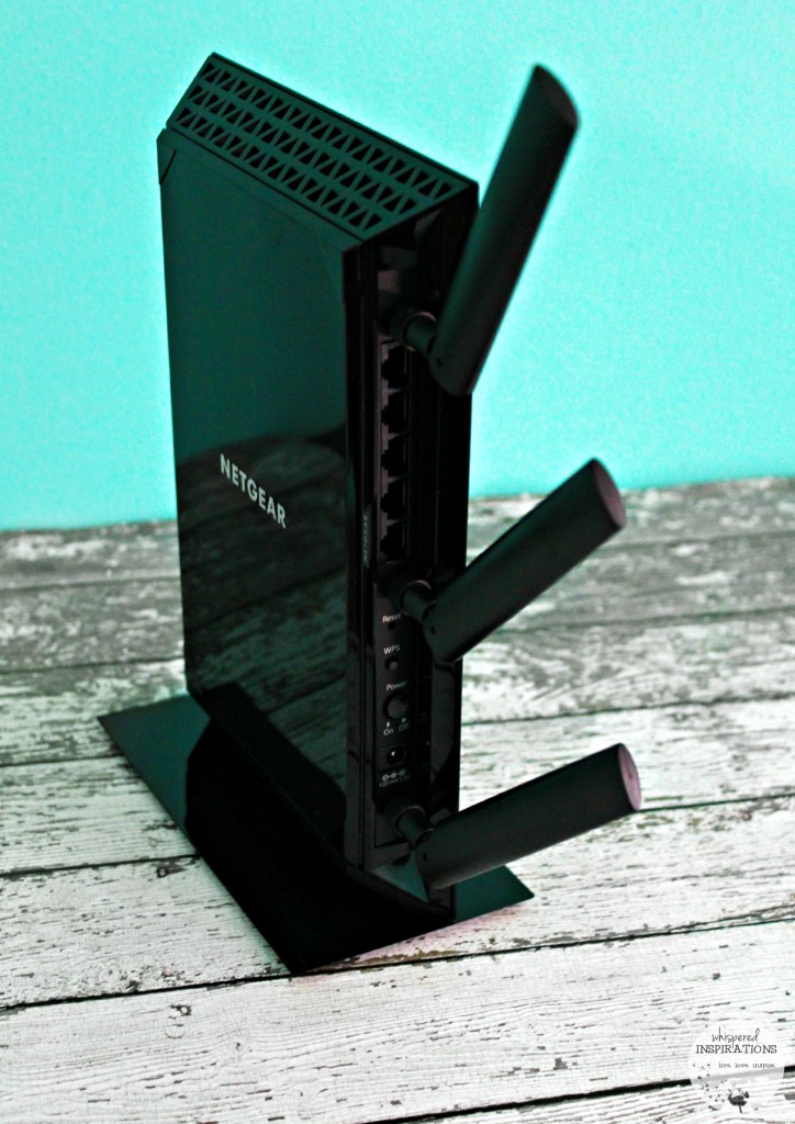 Nighthawk WiFi Range Extender EX7000 antennas are extended as it stands in its mount.