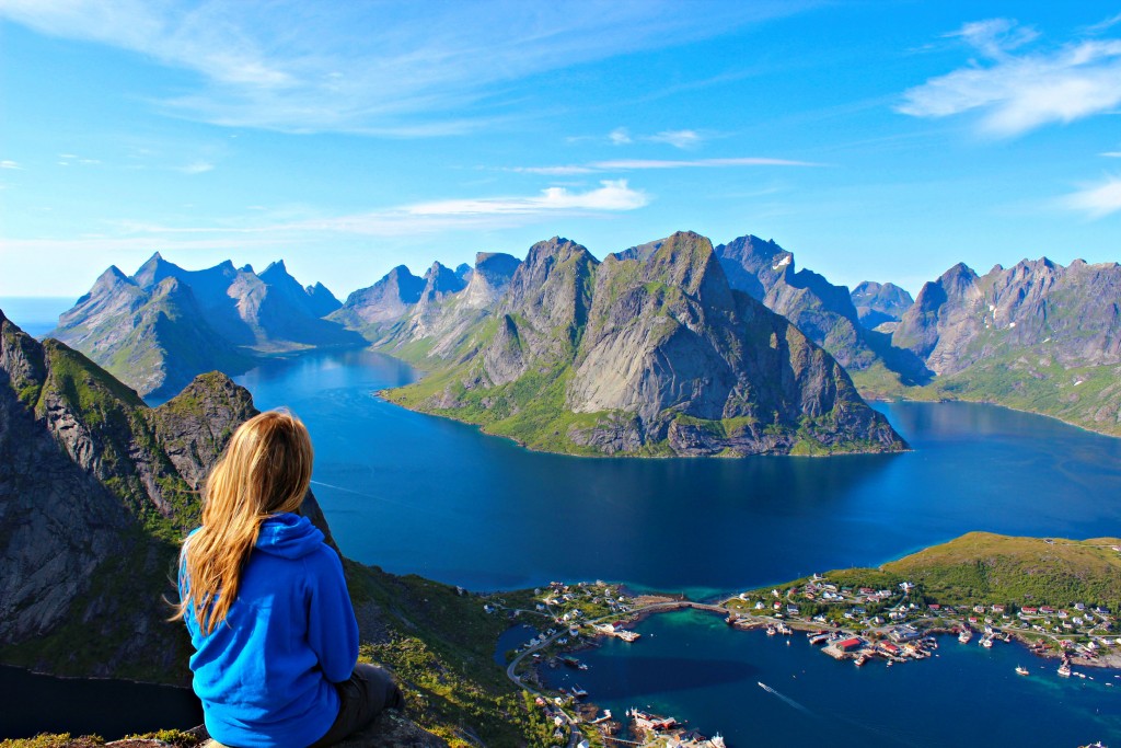 Girl Sits on Edge of Mountains. Travel safe with Allianz Insurance.