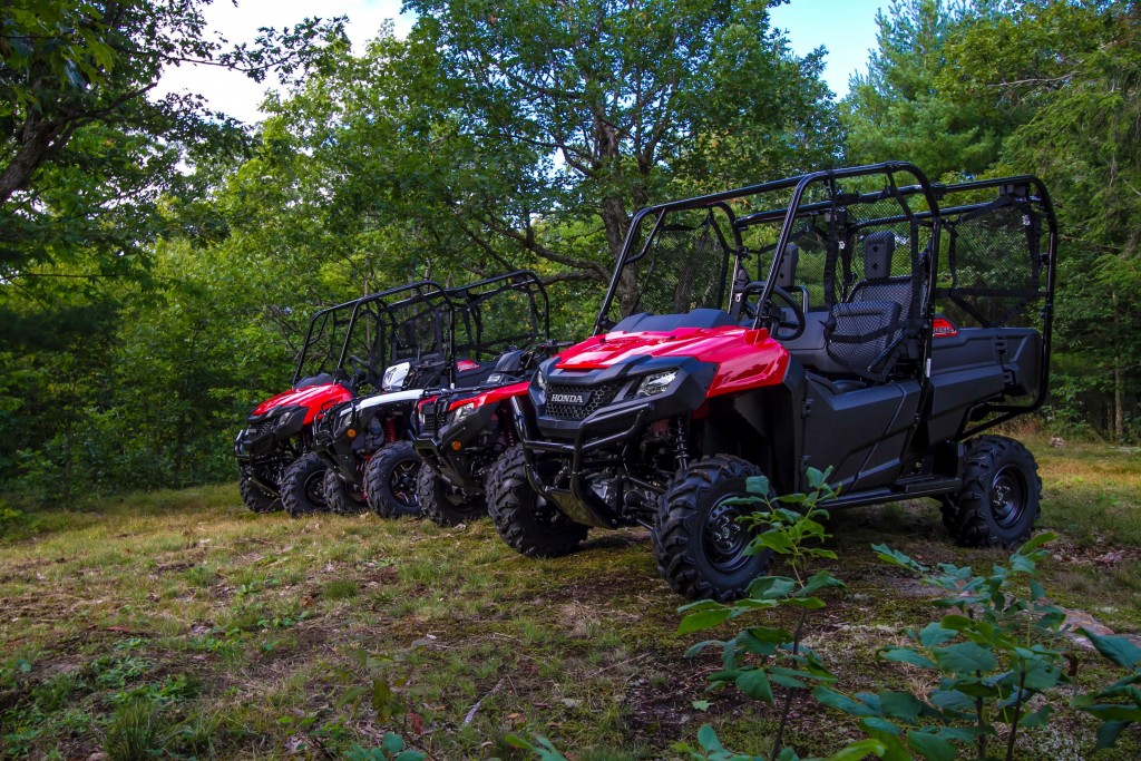 A row of Honda side-by-sides lined up on a hill in Muskoka, Ontario.