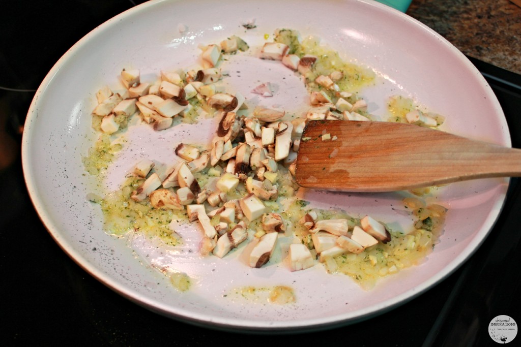 Onion, garlic, and mushrooms being sauteed with butter in a pan.