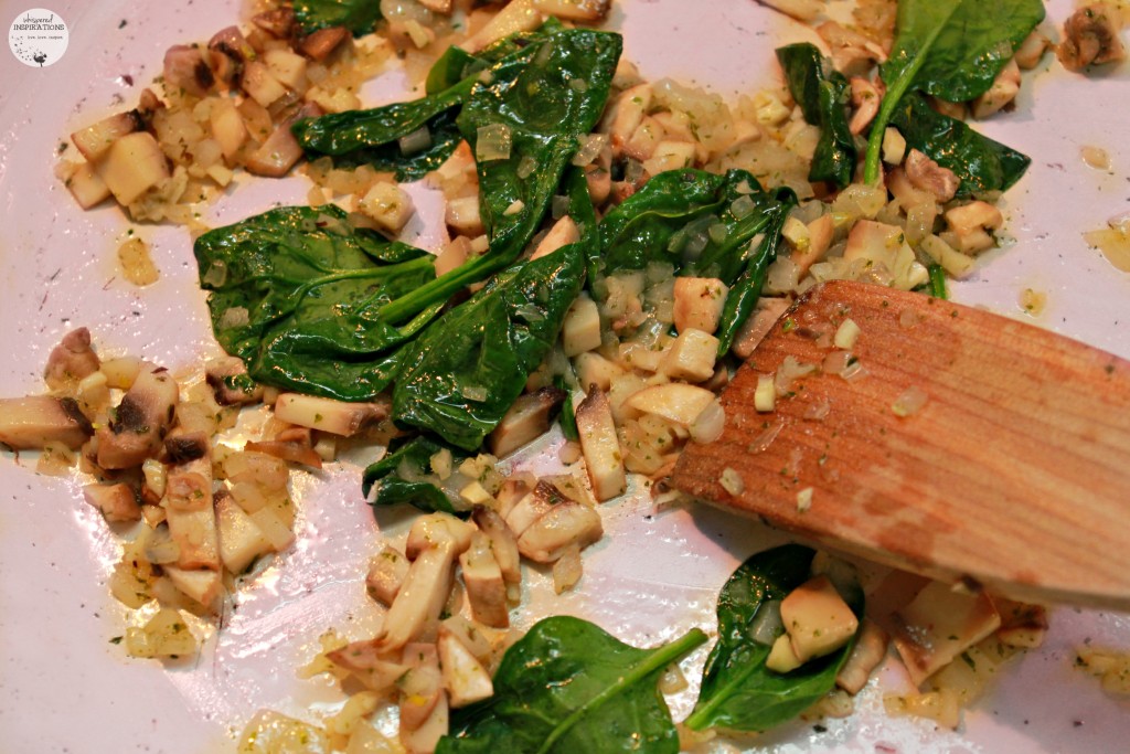 Spinach added to sauteed mushrooms, onion, garlic, and butter. 