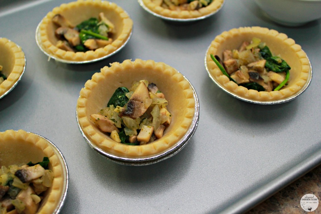 Mini pie shells filled with vegetable mixture.