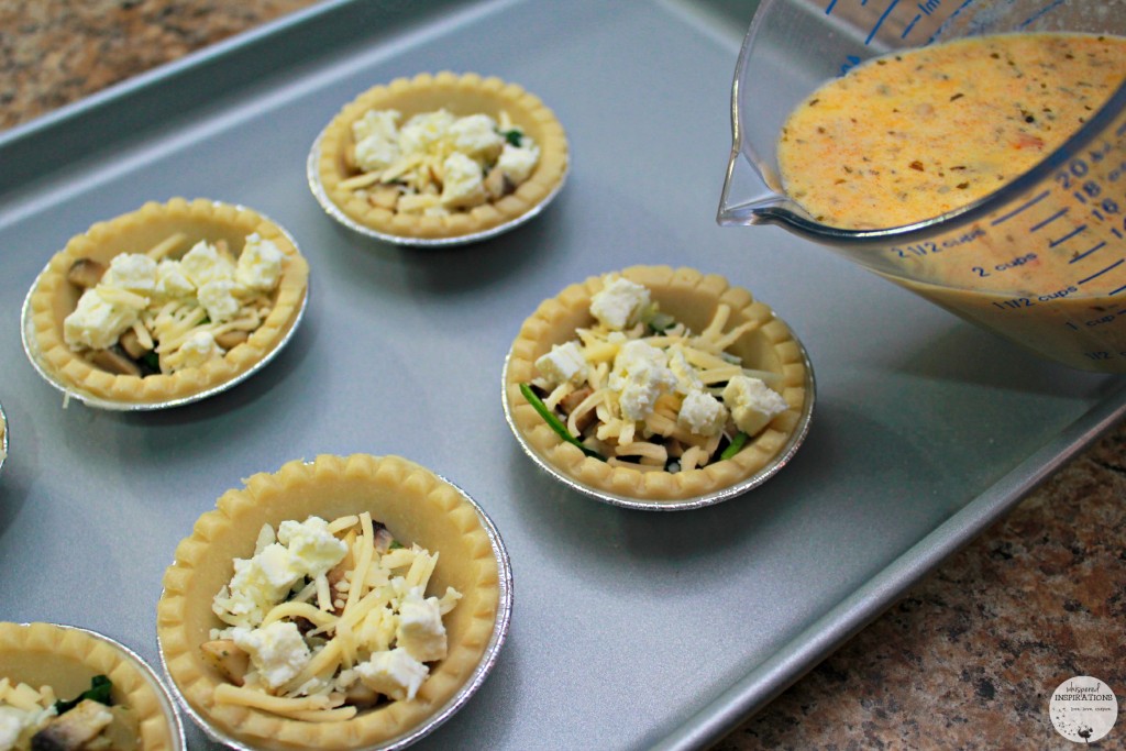 Mini pie shells are then filled with feta and gruyere cheese and being filled with egg mixture. 