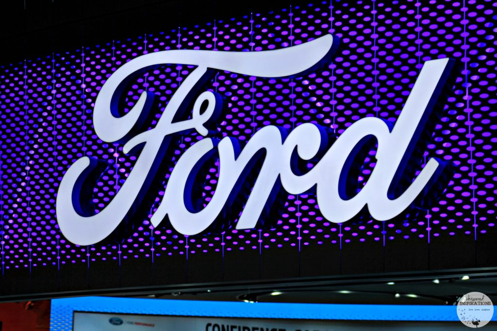A close up of the Ford logo at NAIAS. This article covers when Ford reveals the new 2017 Ford Fusion.