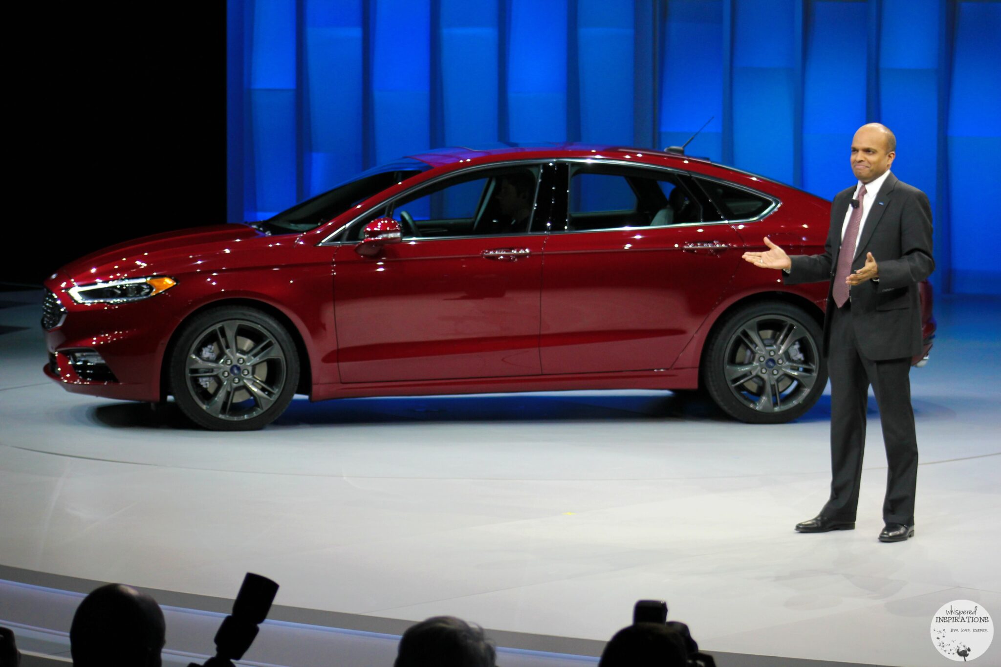 CEO stands with the new Ford Fusion 2017.