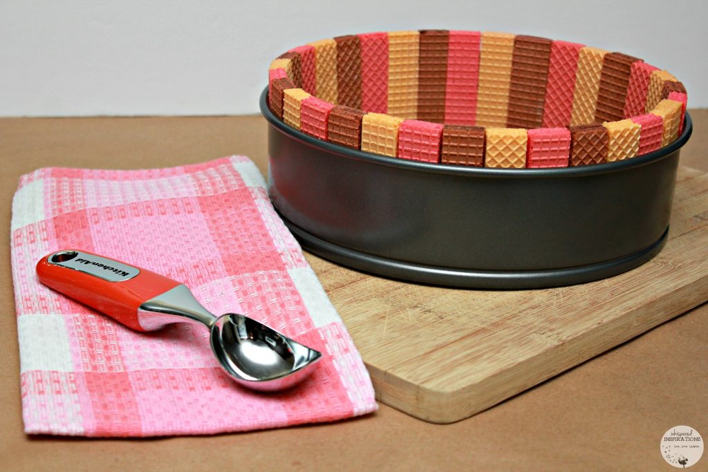 Neapolitan Ice Cream Cake Inspired by Voortman being made, in a springform pan and the cookies are standing up and surround the pan to make a base.