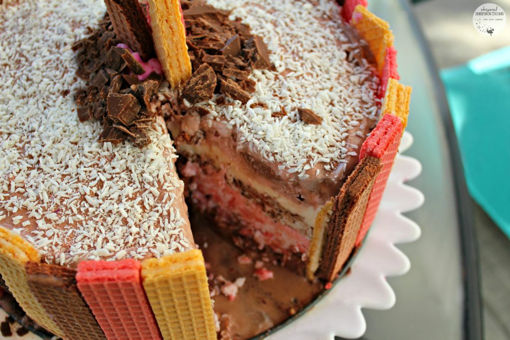 Neapolitan Ice Cream Cake Inspired by Voortman  finished product with a slice taken out. 