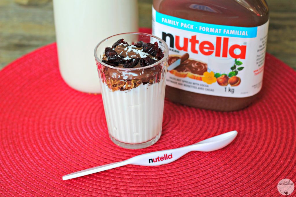 Greek yogurt topped with cranberries, coconut, Nutella, and homemade granola.