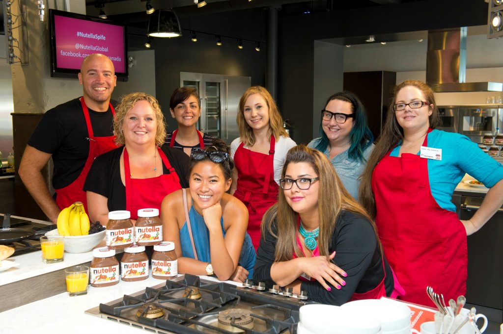 A group of writers in the Nutella kitchen with Chef Faita.