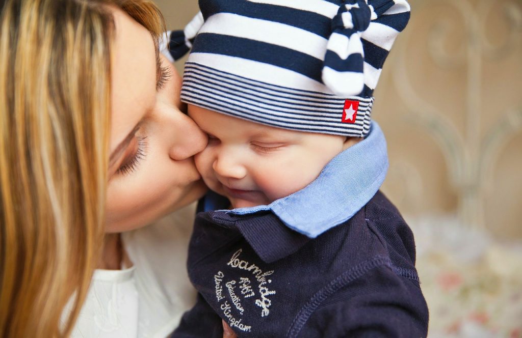 A mother kiss her son on the cheek, he smiles, and he is dressed for the fall. The Graco Maddox 3-in-1 Convertible Crib with KidiComfort Mattress! #BestBuyBaby