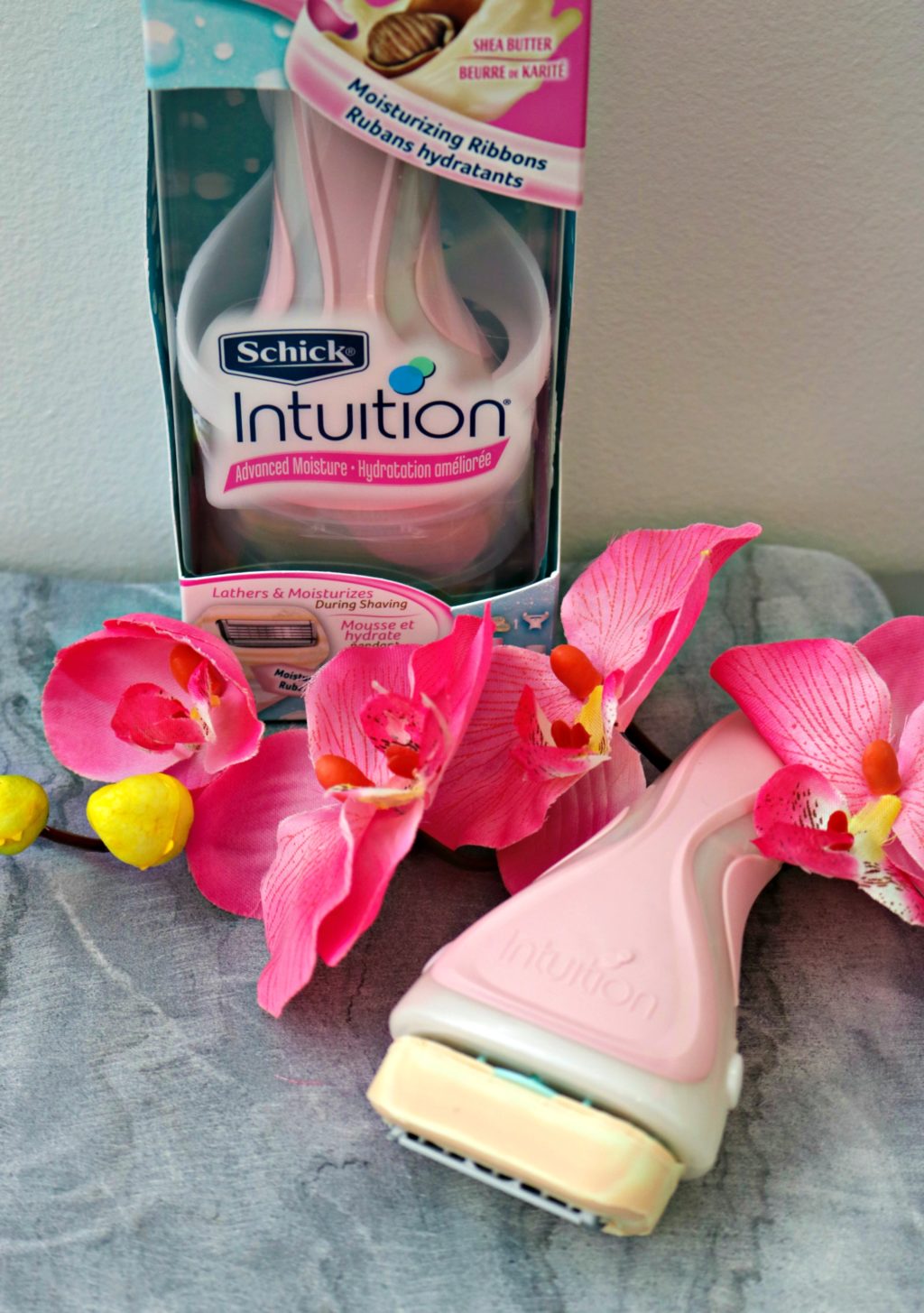 Schick Intuition Razor and flowers. One is inside the box and the other is out. 