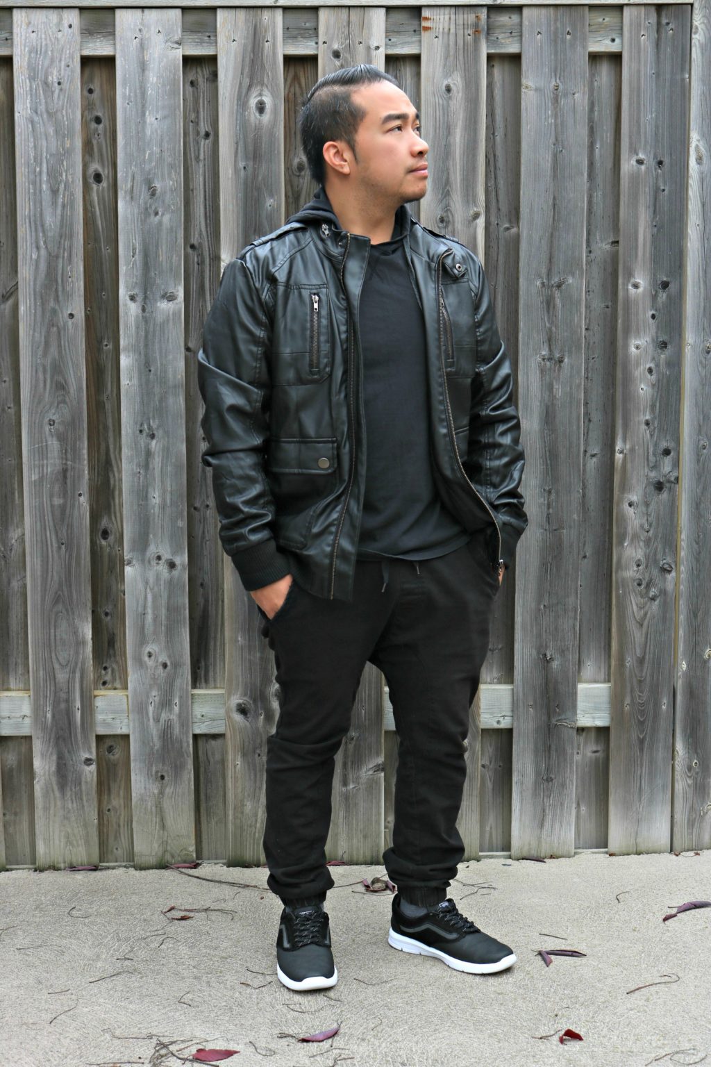 Darasak stands and shows off his outfit, all monochrome black with Vans.