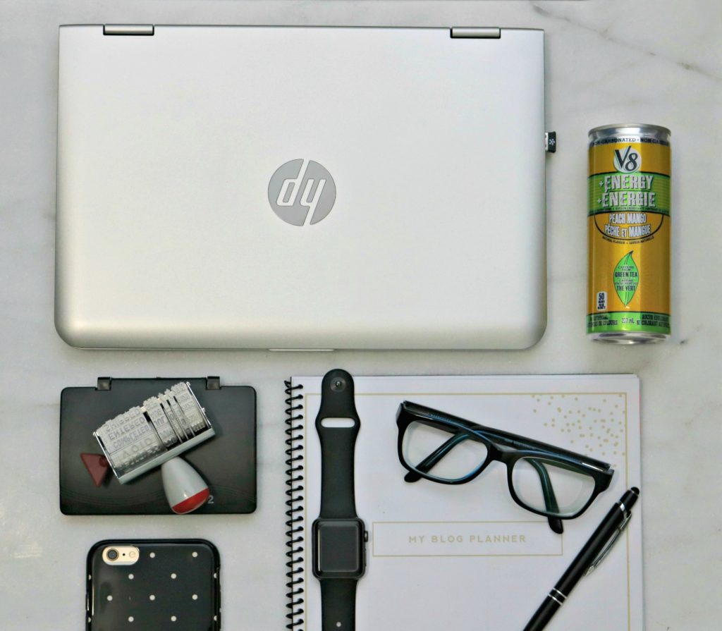 Flat lay of everyday essentials, including V8 Energy Drink. 