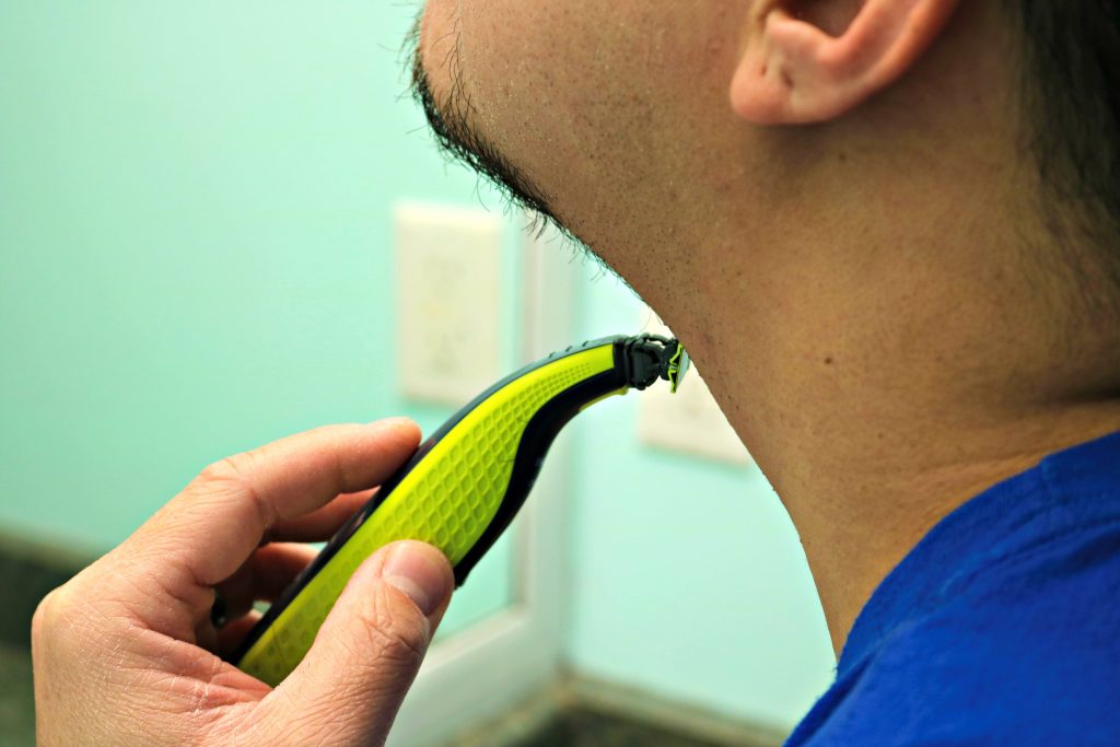A close up of Darasak shaving his neck. 