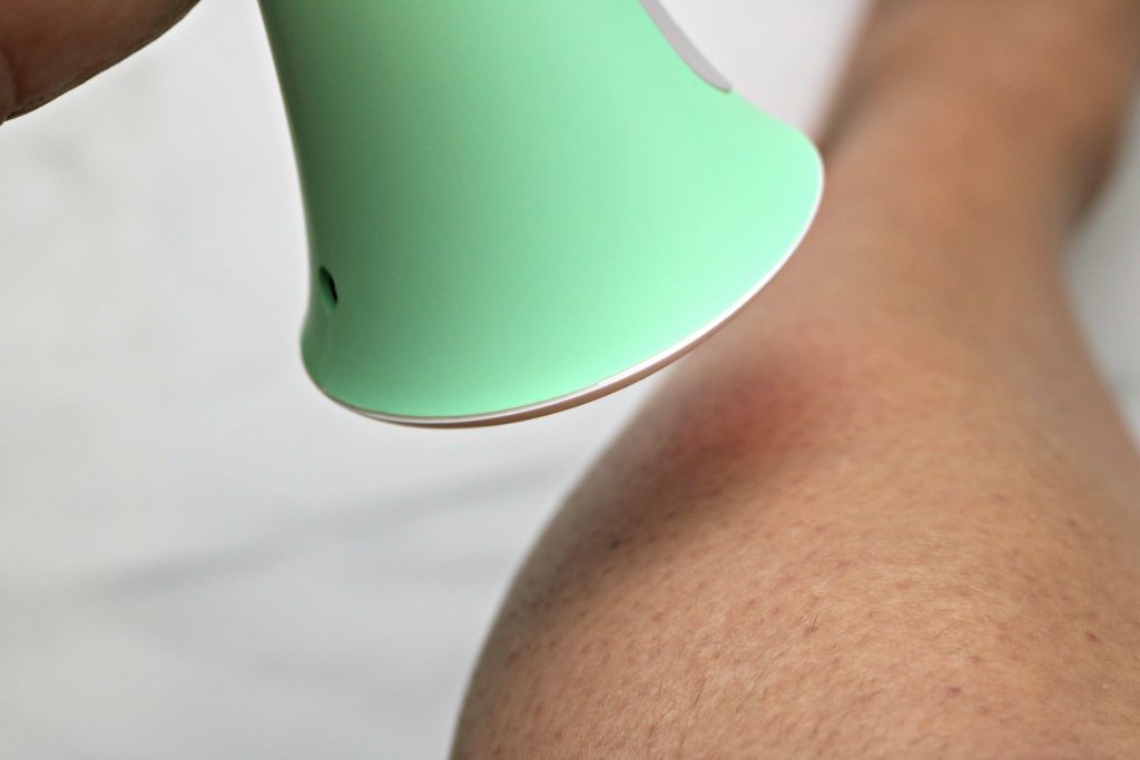 Close up of leg and Tria hair removal tool.