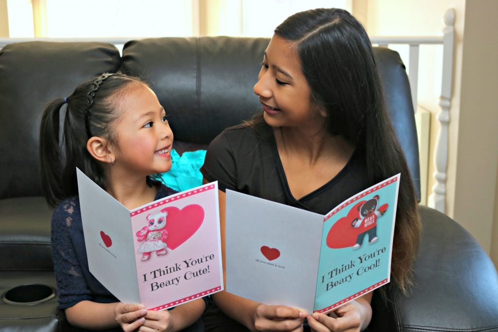 Celebrate Valentine's Day with Build-A-Bear + FREE Beary Cute Valentine's Day Card PRINTABLE! Two little girls exchange Valentine's Day cards.