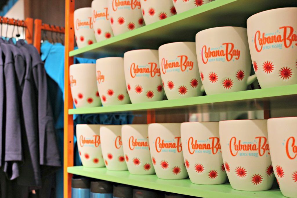 3 rows of Cabana Bay Beach Resort mugs inside the gift shop at the Cabana Bay Beach Resort. 