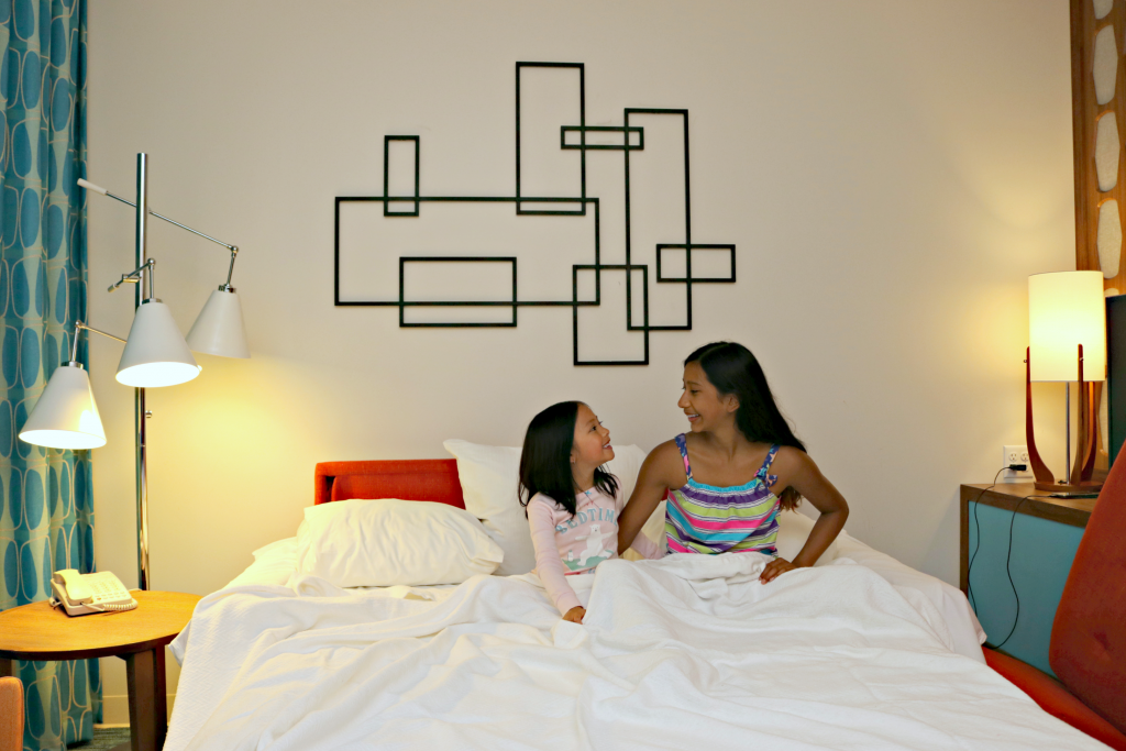 The girls hunker down in the pull out couch in the family suite at Cabana Bay Beach Resort. 