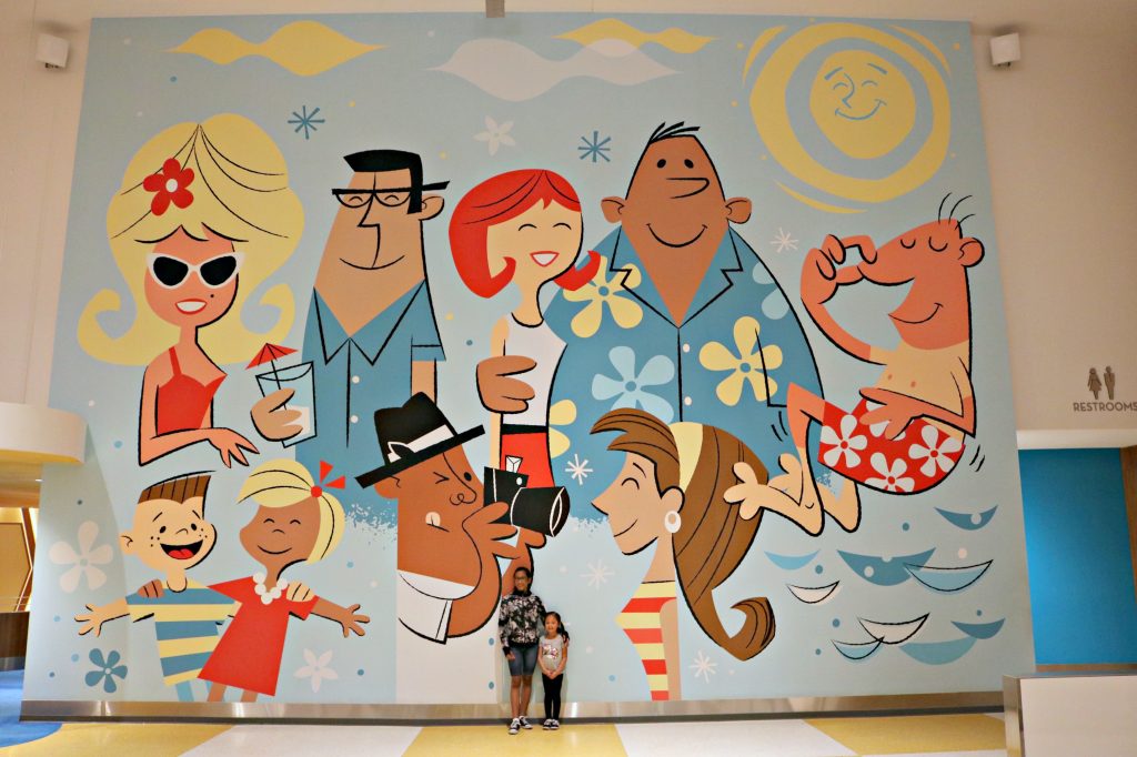A huge mural inside the Cabana Bay Beach Resort, the girls stand in the middle. 