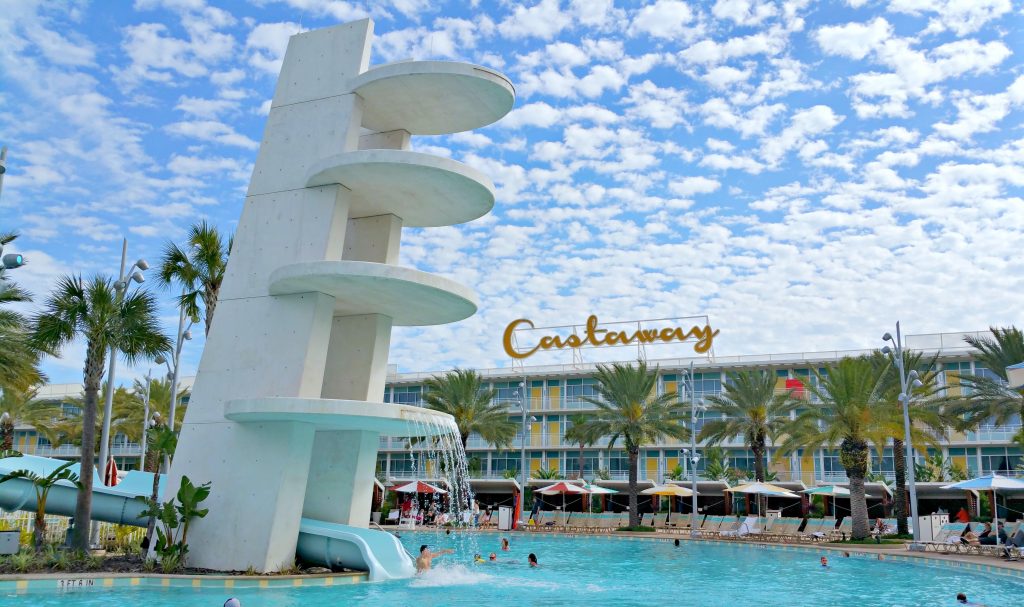 The Castaway Bay Beach Resort fountain, pool, and slides against a beautiful blue sky.