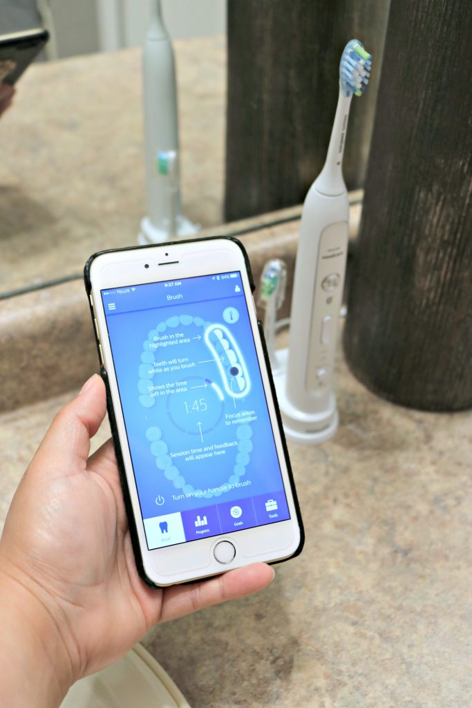 A close up of a phone showing the Sonicare app that helps with smart brushing with Philips.