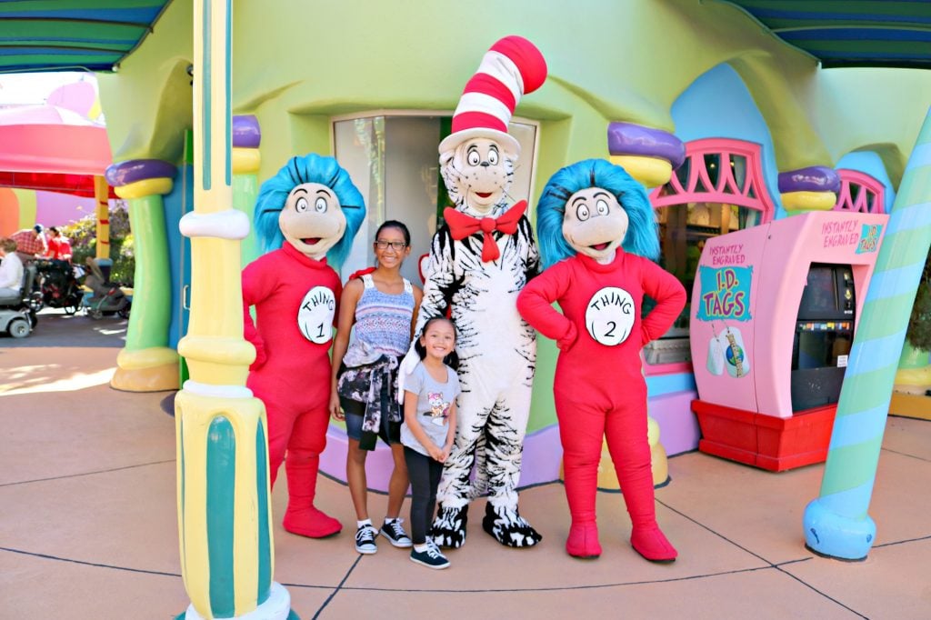 Two young girls stand with the Cat in the Hat and Thing 1 and Thing 2.