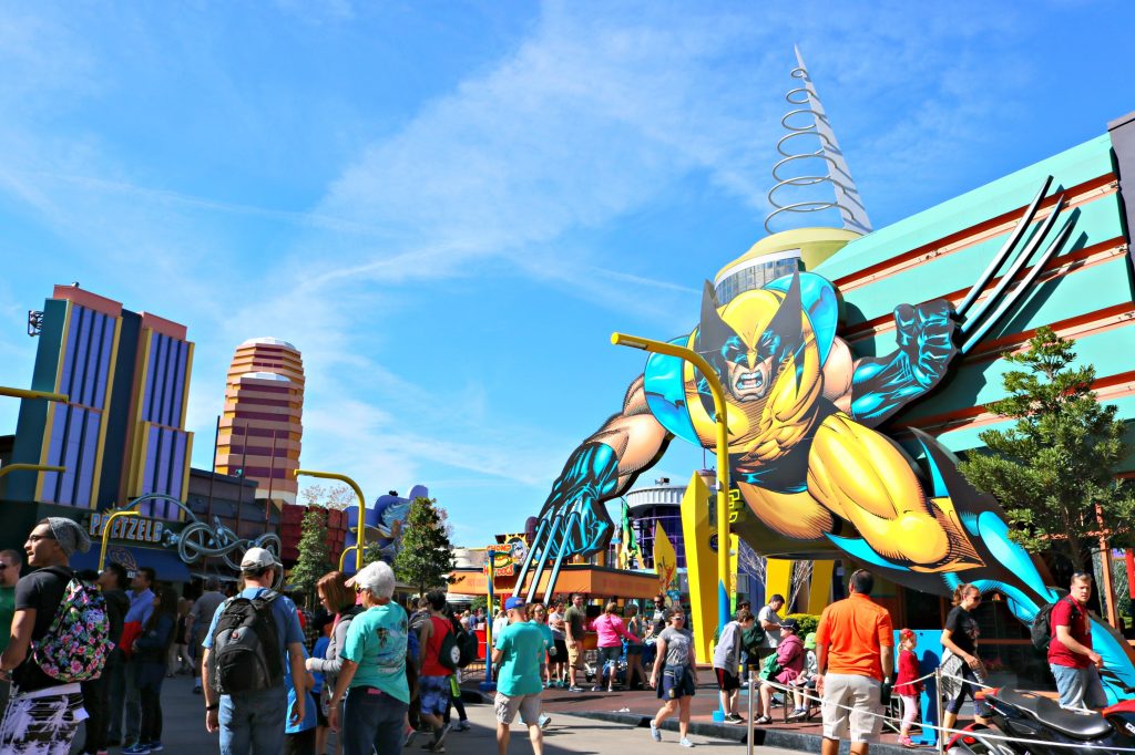 People stand in front of a giant Wolverine on a building at Universal Studios. 