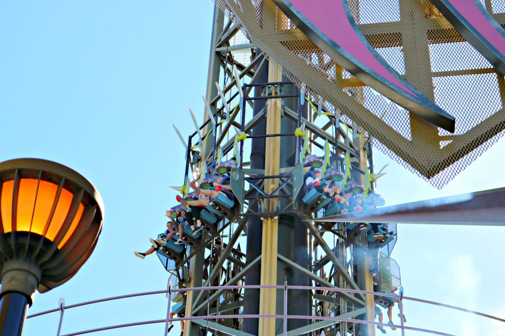 Father and daughter wave from the top of the Dr. Doom ride.