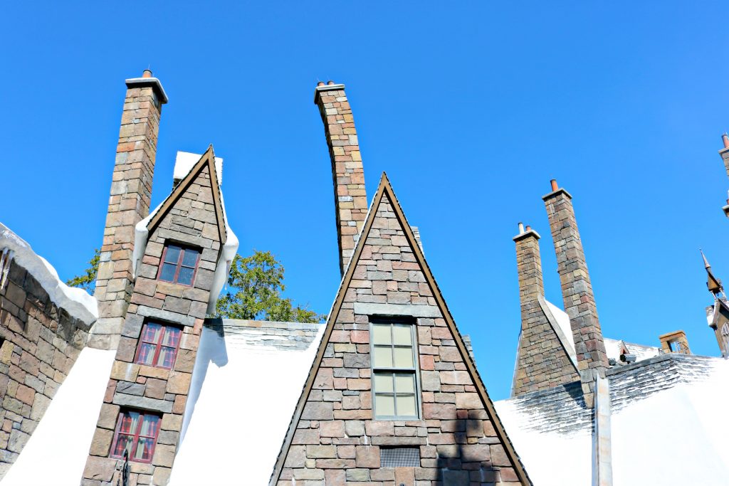 Hogsmeade's twisting buildings topped with snow. 