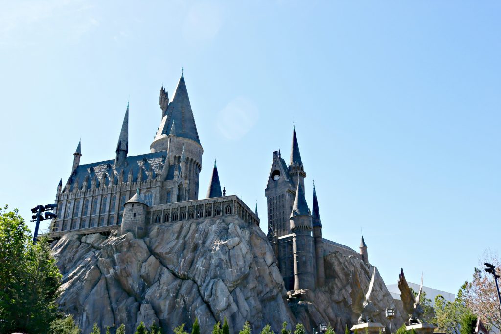 Hogwarts Castle is shown against a beautiful blue sky.