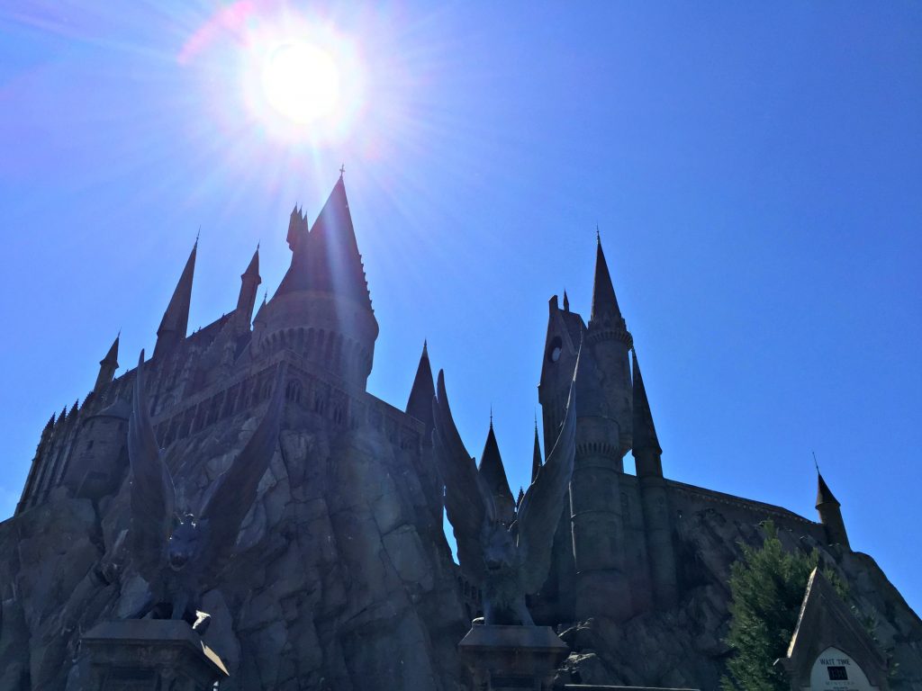 The sun shines bright and high in the sky at Hogwarts Castle. 