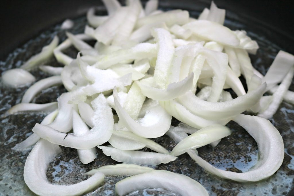 White onions cut and frying in butter.