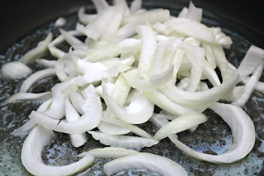 White onions cut and frying in butter.