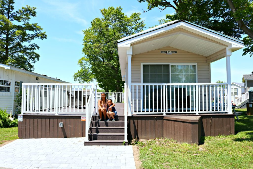 Two girls sit on the steps of a Sherkston Shores property.