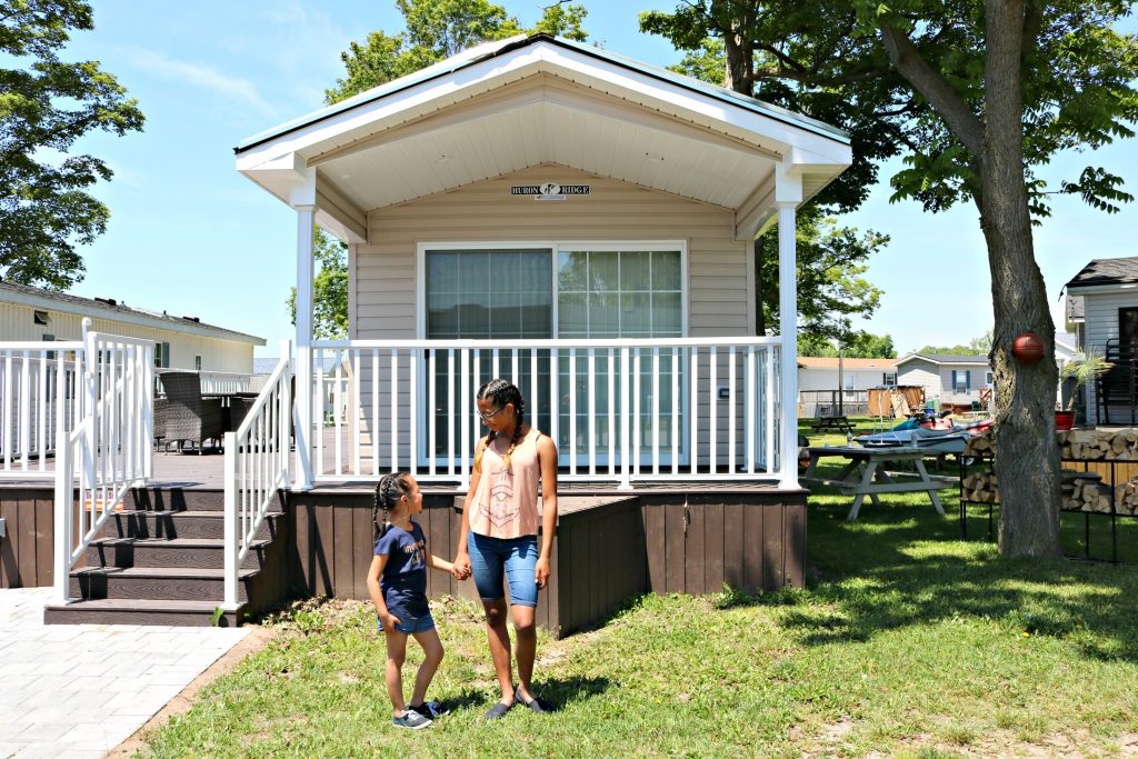 Mimi and Gabby hold hands in front of their Sherkston Shores house.