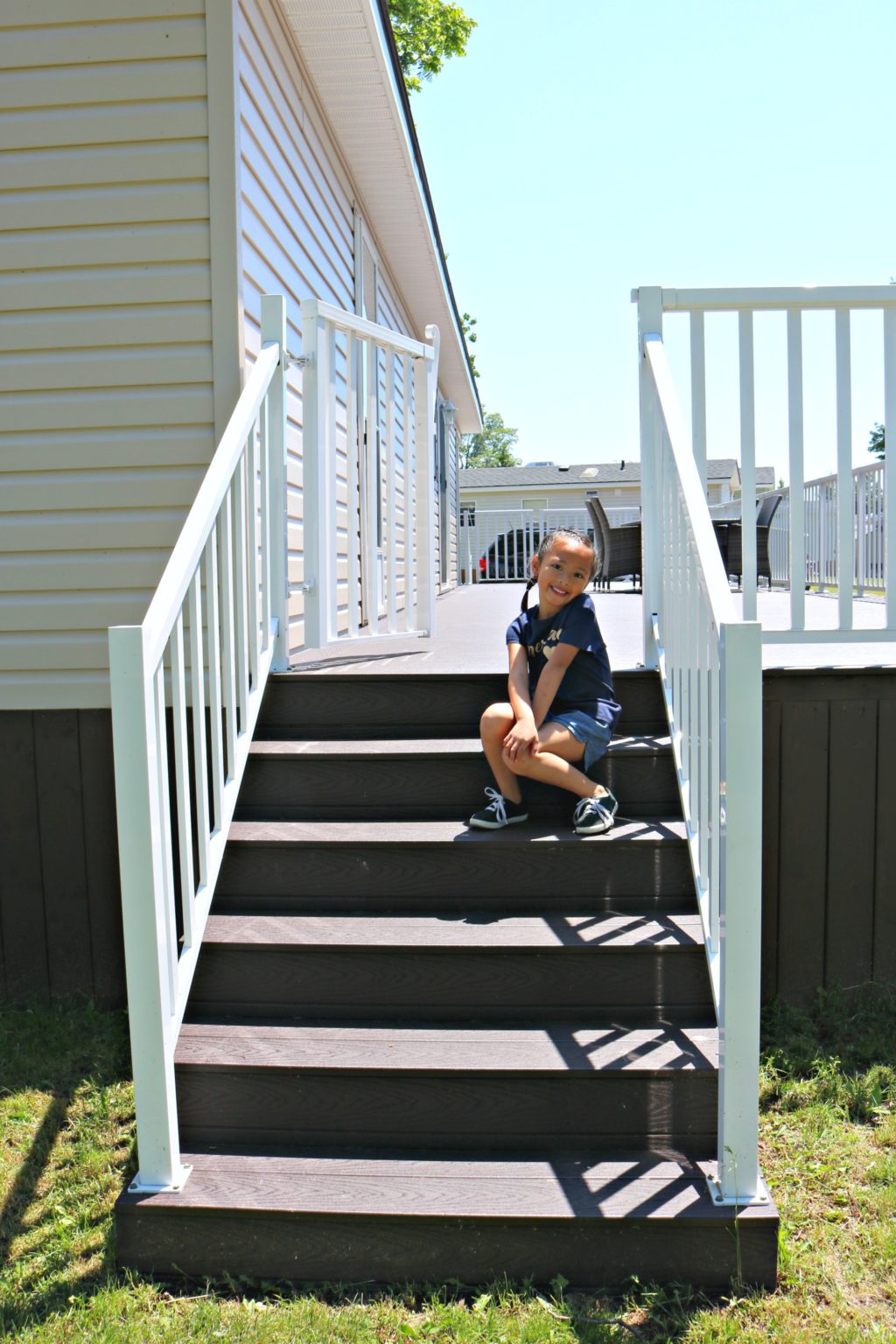 A little girl sits on the steps of the patio at Sherkston Shores.
