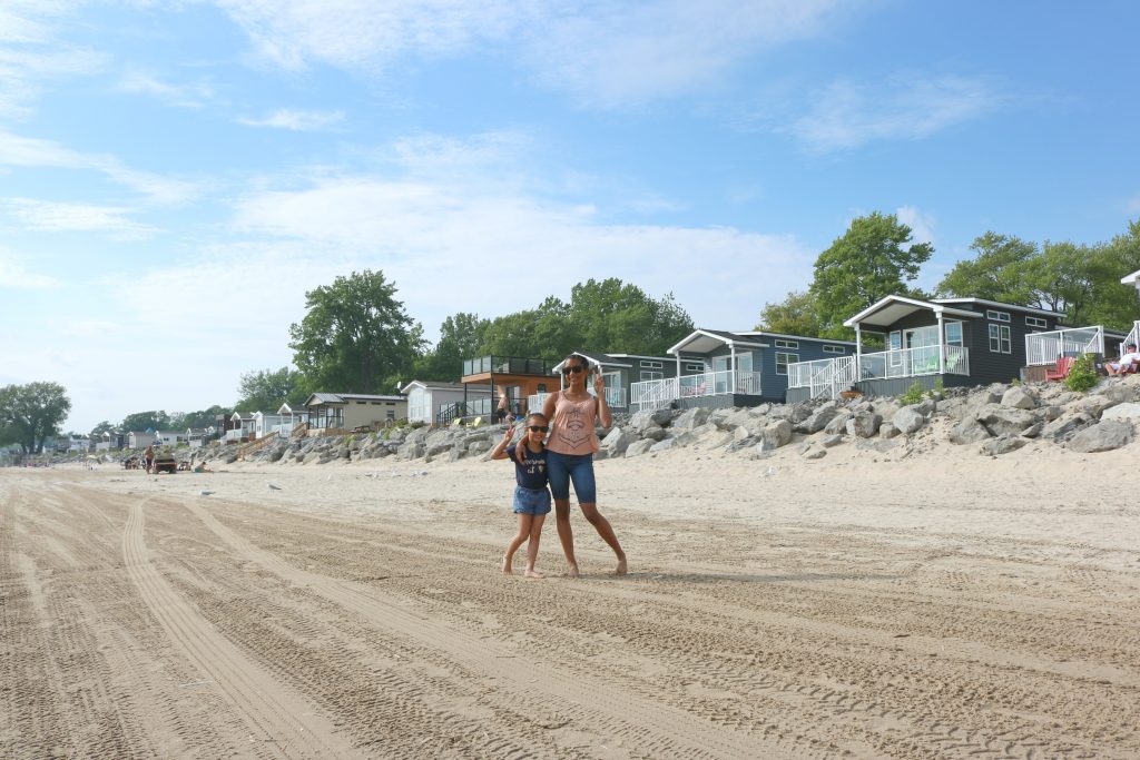 Gabby and Mimi pose at the beach by the beach houses.