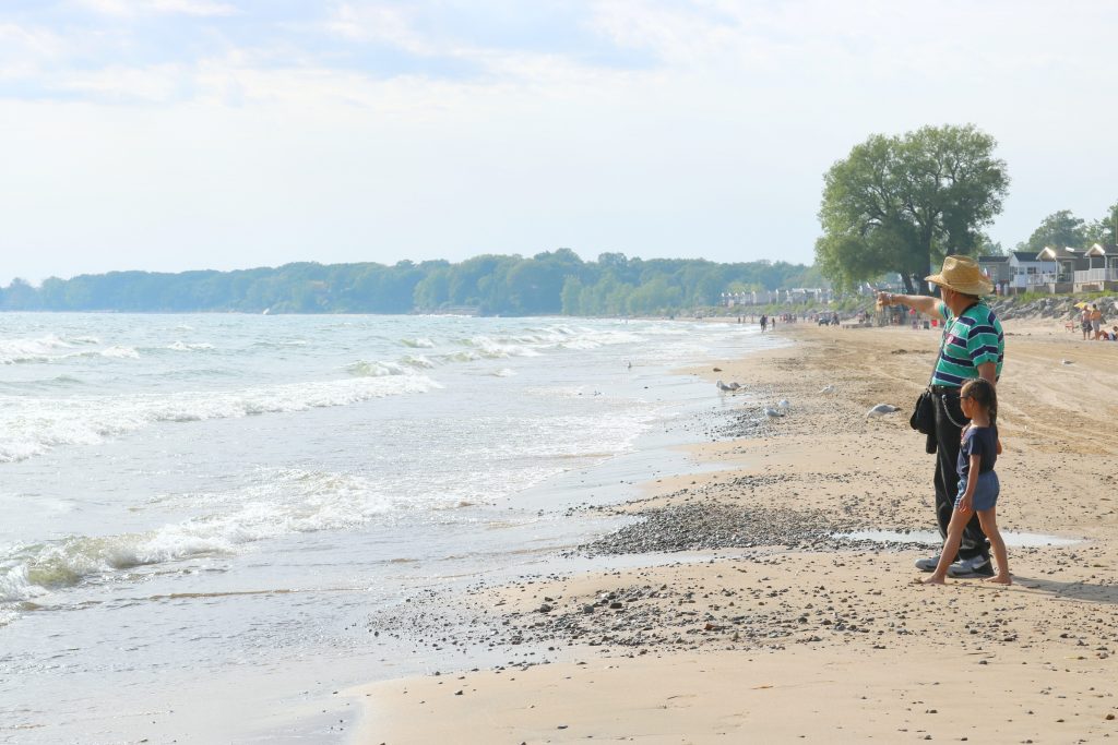 Mimi and her dear Grandpa, Francisco, walk up and down the beach. 