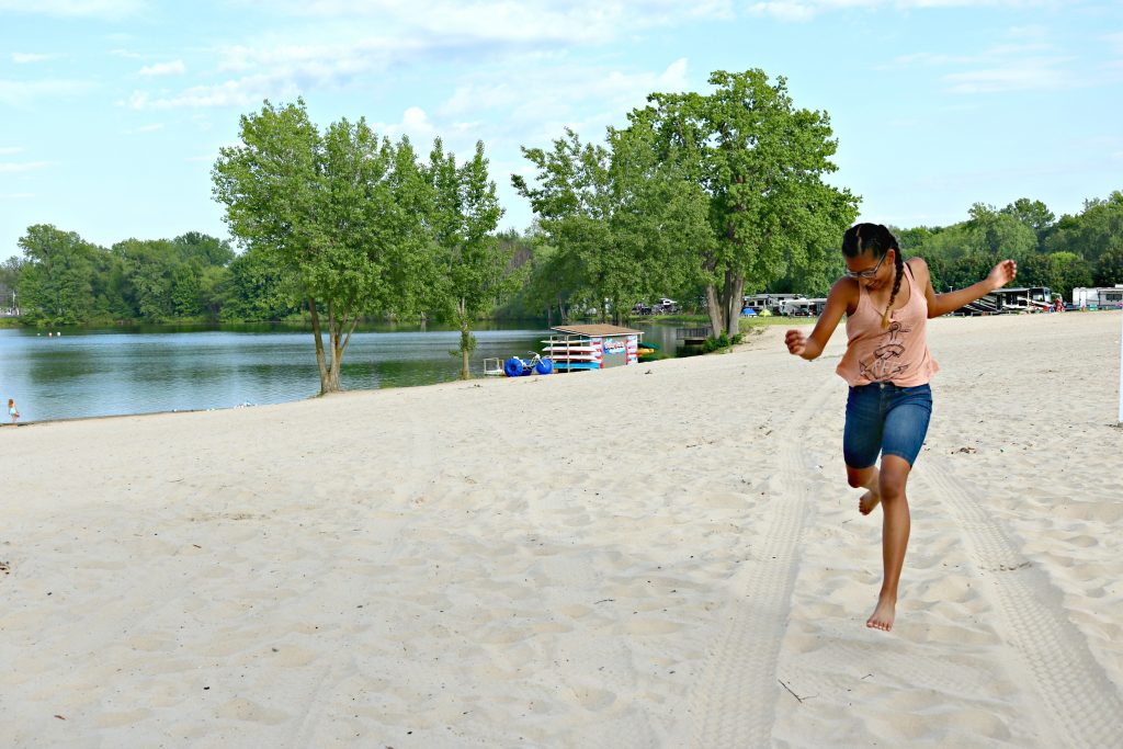 Gabby running down the sand in front of the quarry.