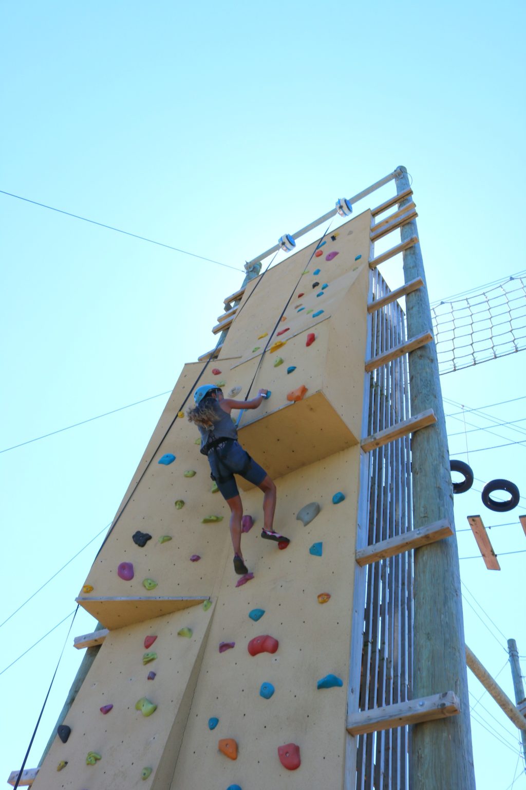 Gabby climbs the rock wall in record time.
