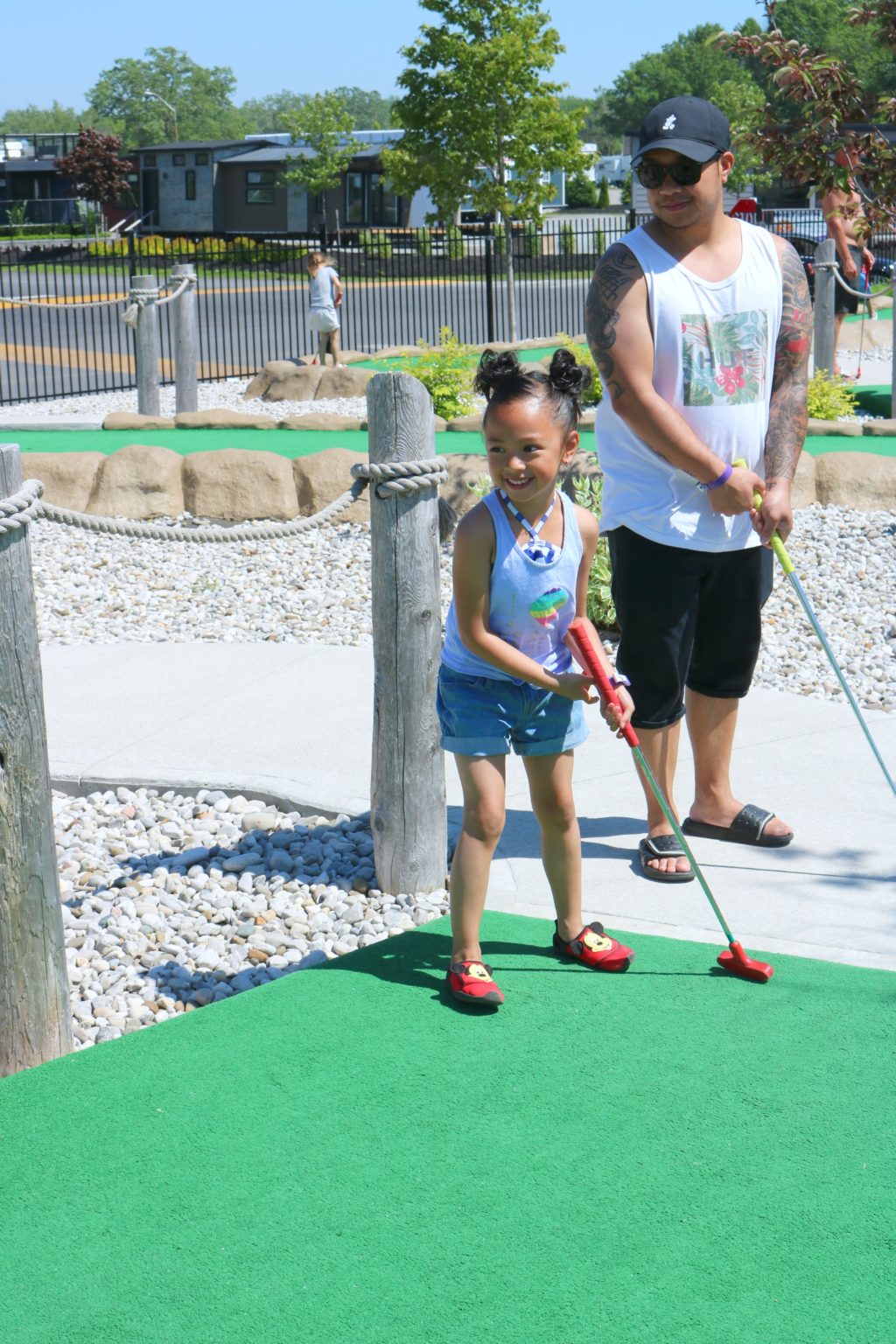 Mimi and Darasak play mini golf at Sherkston Shores.