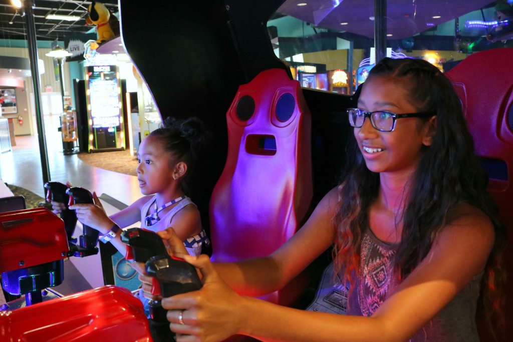 Mimi and Gabriella play at the arcade.