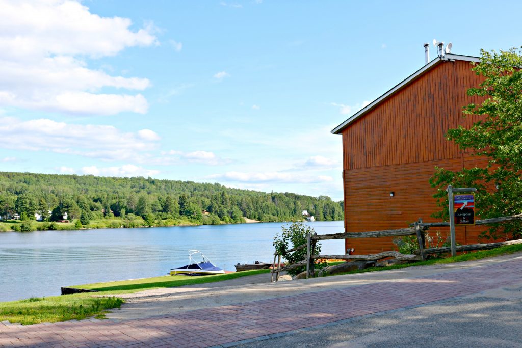 A cabin at Couples Resort outlooks the beautiful greenery and lake. 