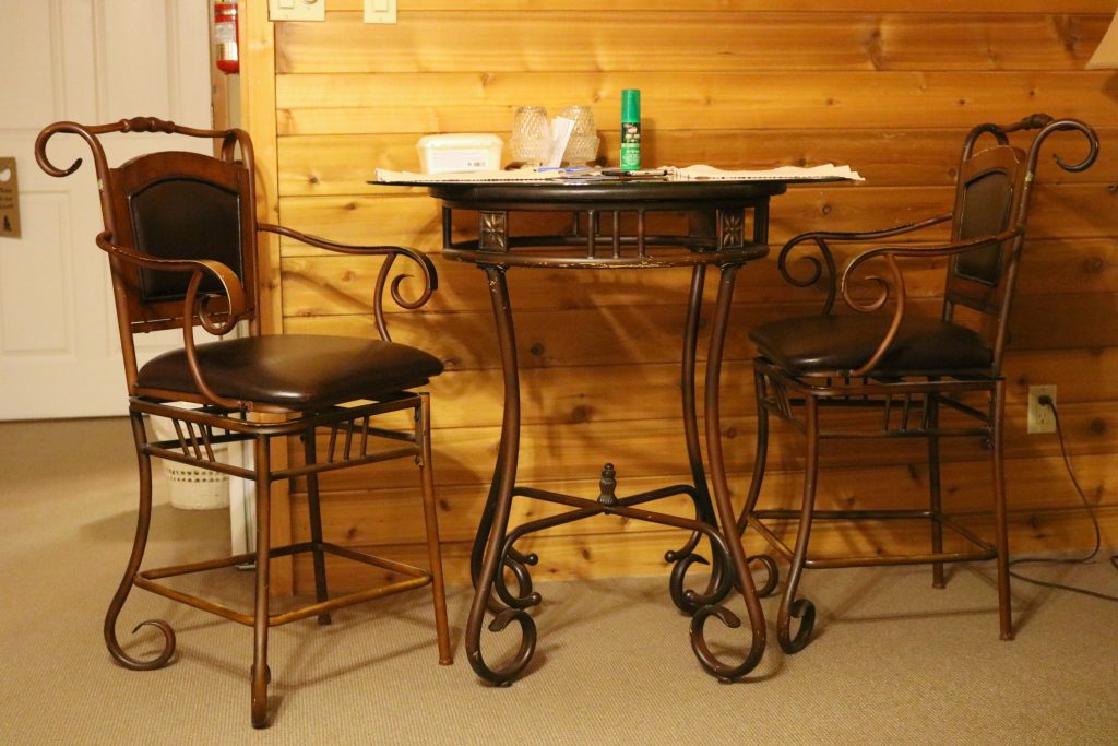 A bistro set for two is shown inside the room. 