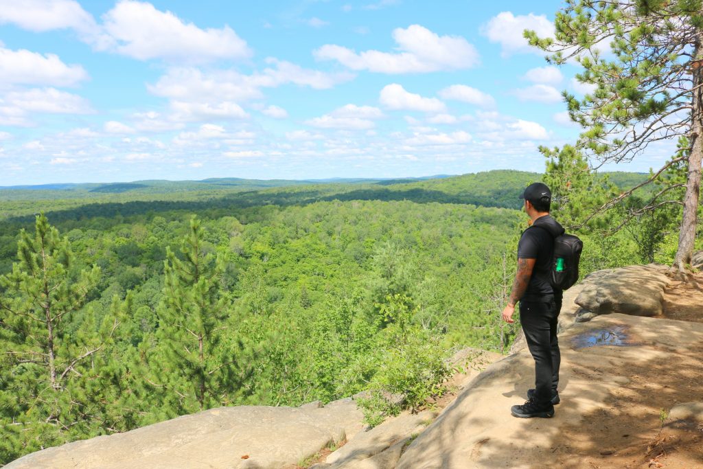 Darasak looks out onto Algonquin from the very top of a walking trail. 