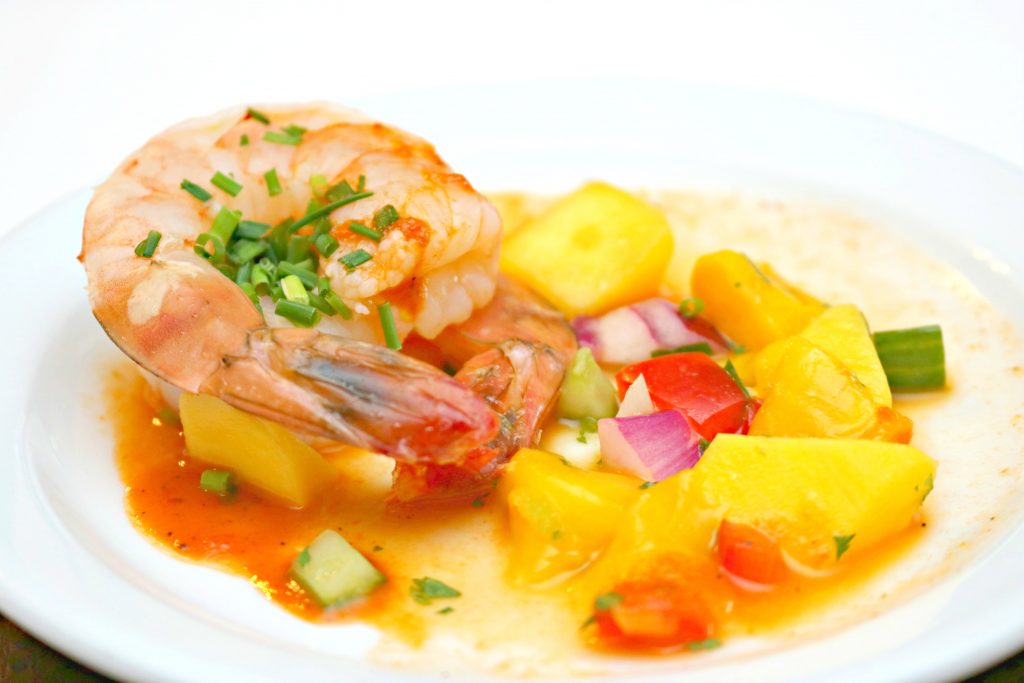 A shrimp appetizer atop a mango chutney. 