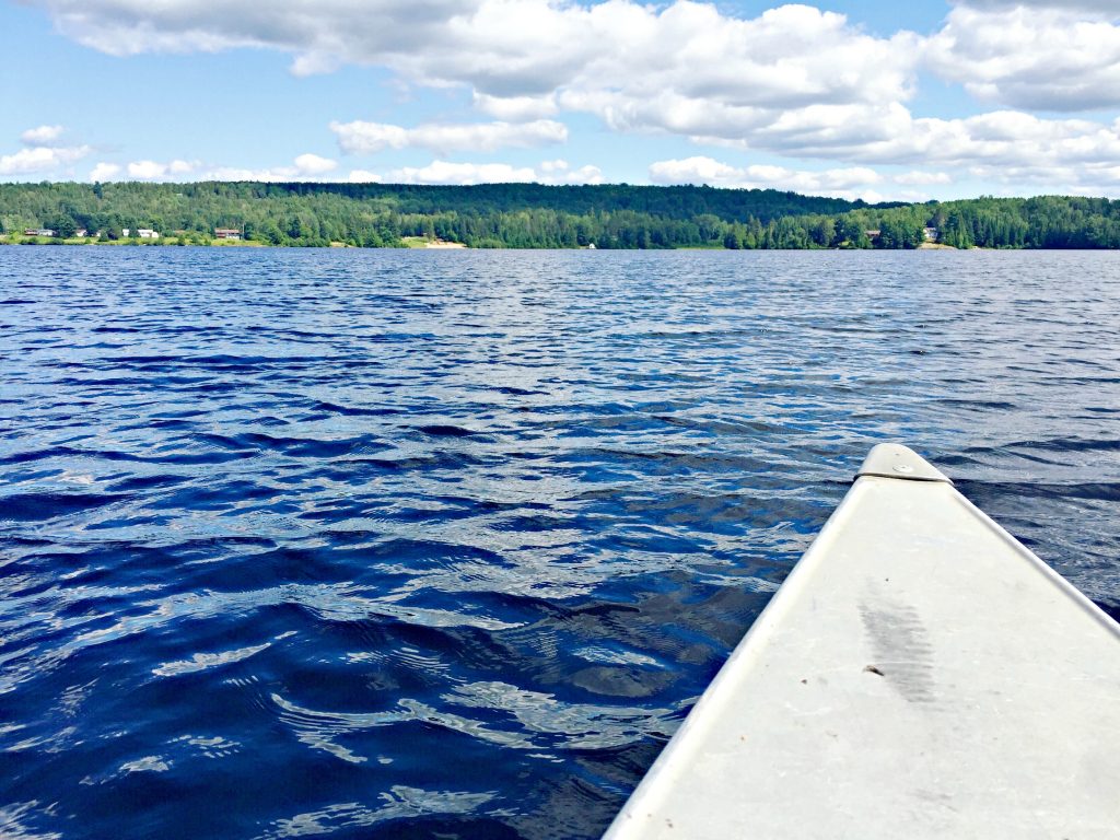 The tip of the canoe on the lake. 