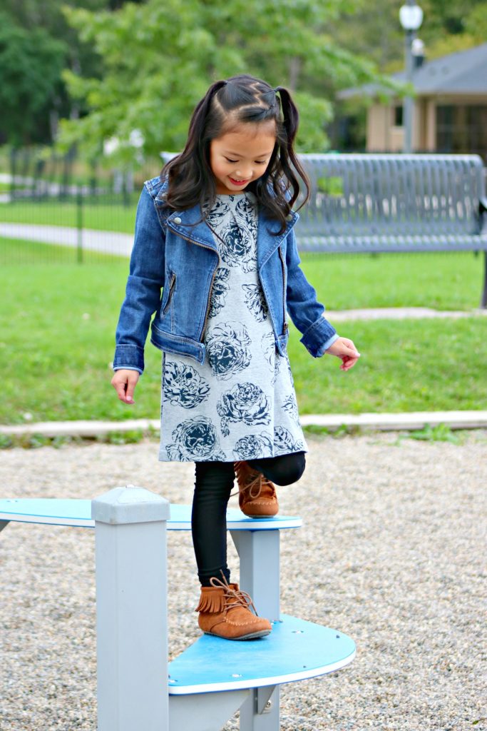 A little girl plays in a playground.