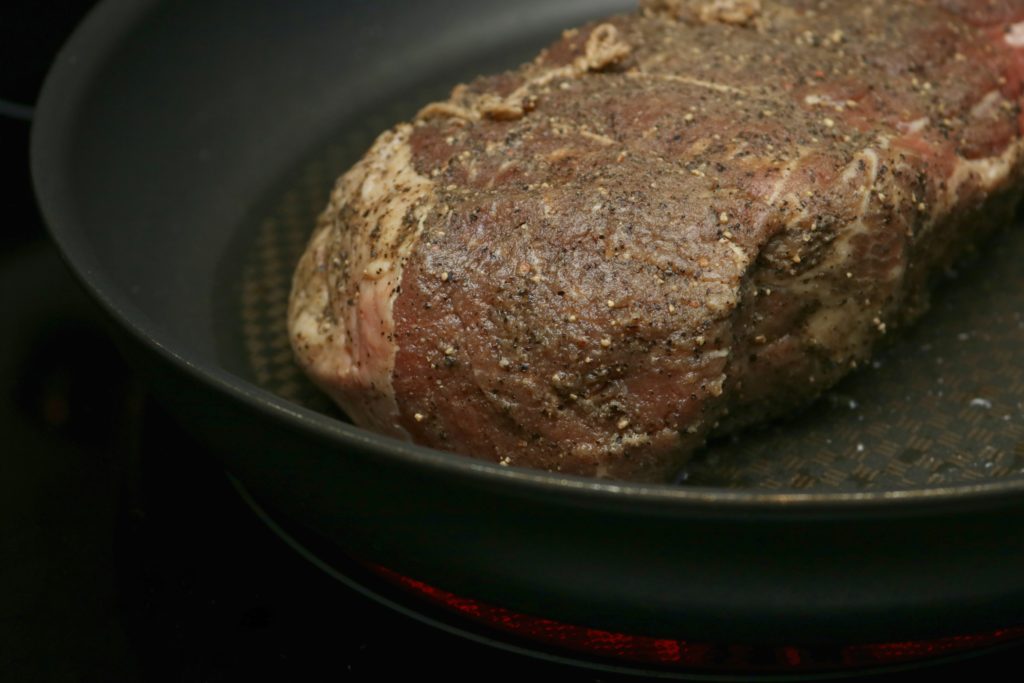 A close up of the beef being seared. 